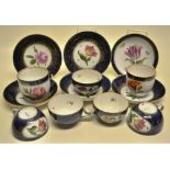 Seven Meissen porcelain cups and six saucers, painted flowers to Royal blue gilt decorated