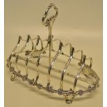 An early Victorian silver oval toast rack, with six graduated shaped up divisions and a central