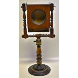 An early Victorian mahogany zogoroscope, with a hinged framed mirror and magnifier on turned