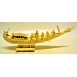 A nineteenth century Indian carved ivory miniature model tusk barge for a Raja, with covered