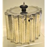 A George III silver oval tea caddy, bright cut engraved fluted sides and hinged cover with lock,