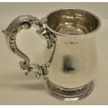 A William IV silver baluster pint mug, with a cast acanthus leaf capped moulded scrolling handle