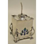 An Edwardian Art Nouveau silver table lighter, the square box with detachable wick, inlaid enamel