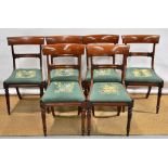 A set of six early nineteenth century mahogany side chairs, the backs with a tulip leaf carved