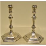 A pair of George 1st cast silver hexagonal tapersticks, with knopped stems and engraved a crest to