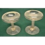A pair of late eighteenth century glass individual oil lamps, the compressed bowls on writhen