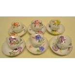 A set of six nineteenth century Meissen porcelain coffee cups and saucers, hand painted flowers gilt