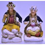 Two early nineteenth century Staffordshire figures of seated Turks, wearing a blue coat and turbans,