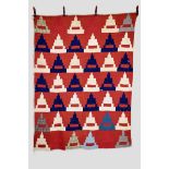 American quilt in red, blue and white cottons with a few check cottons depicting rows of