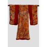 Japanese child’s printed silk kimono, with lightly padded hem, lined with orange silk and with red