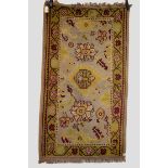 Ushak rug, west Anatolia, circa 1930s, 5ft. 5in. x 3ft. 1in. 1.65m. x 0.94m. Overall wear; sides