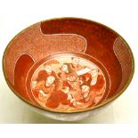 A Japanese red decorated porcelain bowl of a lion standing by bamboo and two horses frolicking in