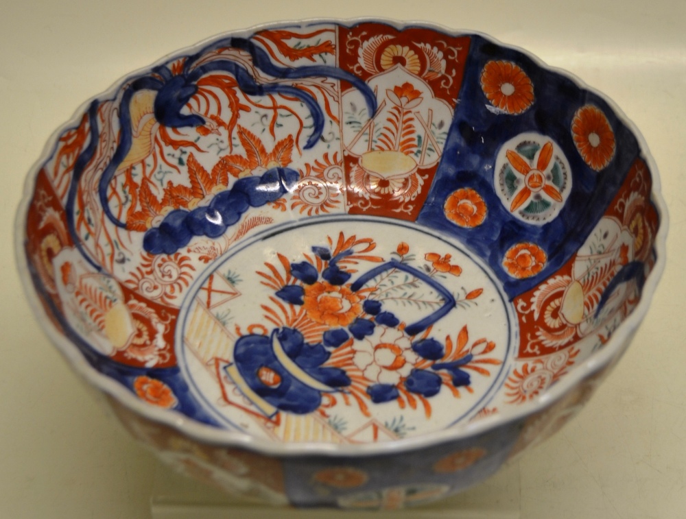 A Japanese Imari porcelain bowl the centre in rust and blue decorated a tub of flowers, the ribbed