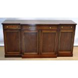 A mahogany breakfront dwarf side cabinet, the well figured veneered top above three frieze
