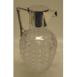 A George V glass claret jug, with hobnail cutting, a silver mounted neck with hinged cover and a