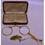A nineteenth century gold pince nez, with engraved handle and a gilt chain, in a case.