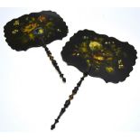 A pair of Victorian black papier mache face shields, painted flowers, having a serpentine border, (