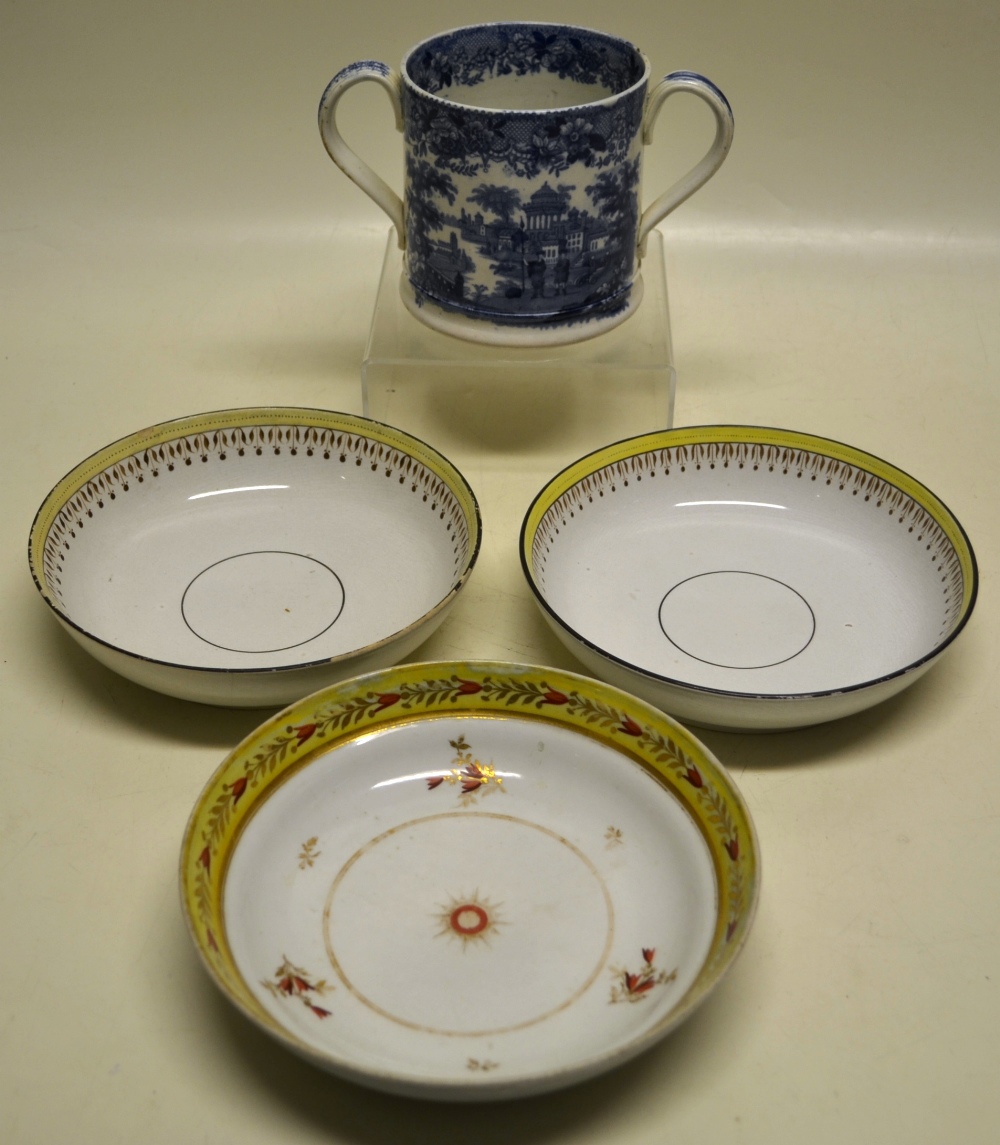 An early Victorian Staffordshire ware two handled cup, decorated a blue and white transfer of a view
