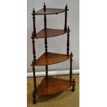 A Victorian rosewood corner etagere, the four graduated bow front shelves with finials, on turned