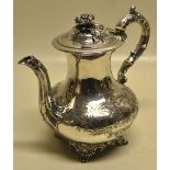 A Victorian silver baluster coffee pot, engraved scrolling foliage with a vacant cartouche one side,