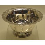 An early George III silver bowl, part fluted sides with chased foliage and a chased border moulded