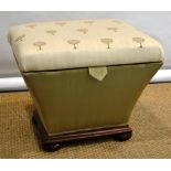 A Victorian ottoman stool, the upholstered hinged rectangular lidded seat on tapering sides to a