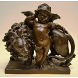 A eighteenth century French bronze group, of a helmetted cupid standing by a lion, the rectangular