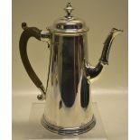 A silver coffee pot in George 1st style, the tapering body with a part fluted capped swan neck