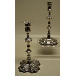 A pair of early George III cast silver candlesticks, the spool shape candleholders with detachable