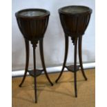 A pair of Edwardian mahogany jardiniere stands, with slatted sides and brass liners, on splayed