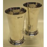 A matched pair of Irish silver beakers, trumpet shaped with either a reeded ribbon tied or Celtic