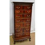 An Edwardian Irish mahogany tall narrow chest, the dentil cornice with a blind fret frieze, the