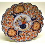 A late nineteenth century Japanese Imari porcelain circular dish, decorated in blue and red, an