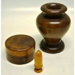 A treen walnut powder box and cover. 3.5in (9cm). A treen acorn shape needle case. 2.75in (7cm). And