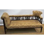 A late Victorian carved walnut show frame settee day bed, with upholstered back rail to a corner