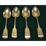 Four early nineteenth century Irish silver fiddle pattern table spoons with a rat tail bowl, a
