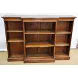 A Victorian walnut veneered dwarf breakfront open bookcase, the top cross banded, bordered with