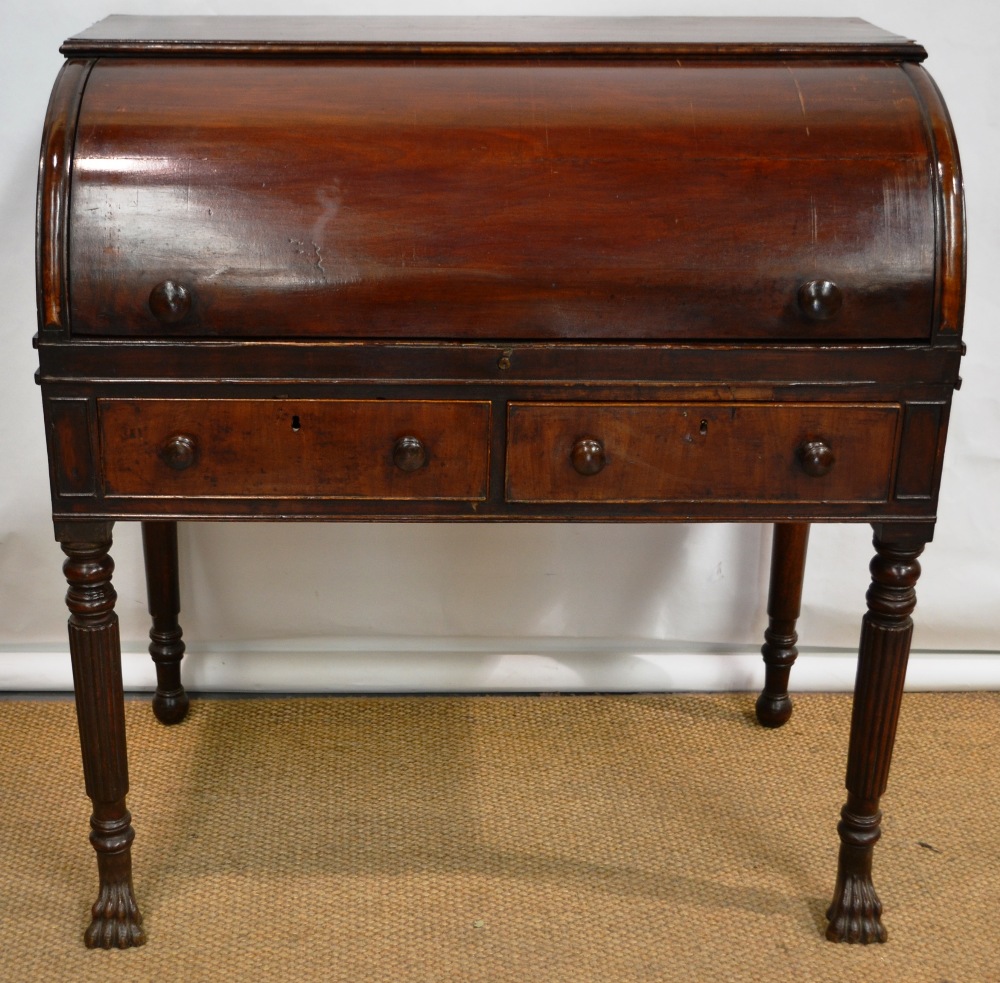 An Regency Irish mahogany roll top desk, the fitted interior with drawers and pigeon holes, a pull