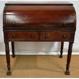 An Regency Irish mahogany roll top desk, the fitted interior with drawers and pigeon holes, a pull