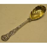 A Victorian silver Bacchanalian pattern cast dessert serving spoon, with a part fluted bowl,