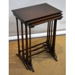 A nest of three Edwardian mahogany graduated occasional tables, the rectangular tops on twin