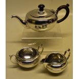A bachelor's silver three piece tea service, the circular bodies with a girdle moulding, the