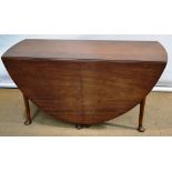 A large Irish Cuban mahogany double gateleg table, the oval dropleaf top above a frieze drawer