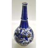 A Persian blue and white decorated stoneware bottle vase, decorated a fire and flowers, blue ribbing