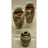 A small pair of Japanese late nineteenth century Kutani porcelain baluster vases, decorated panels