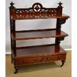 A Victorian Irish mahogany buffet, the top shelf with a raised pierced carved crest, with a domed