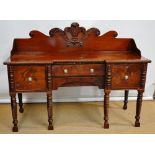 An early nineteenth century Irish mahogany sideboard, the galleried back carved with the Prince of
