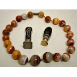 A string of agate beads necklace, approximately 14in (41cm). Together with two seals. (3)