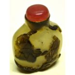 A Chinese carved agate snuff bottle, decorated with two sages in a landscape, a rose glass