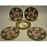 A set of four Edwardian Wedgwood bone china plates, decorated in coloured enamels, Oriental style